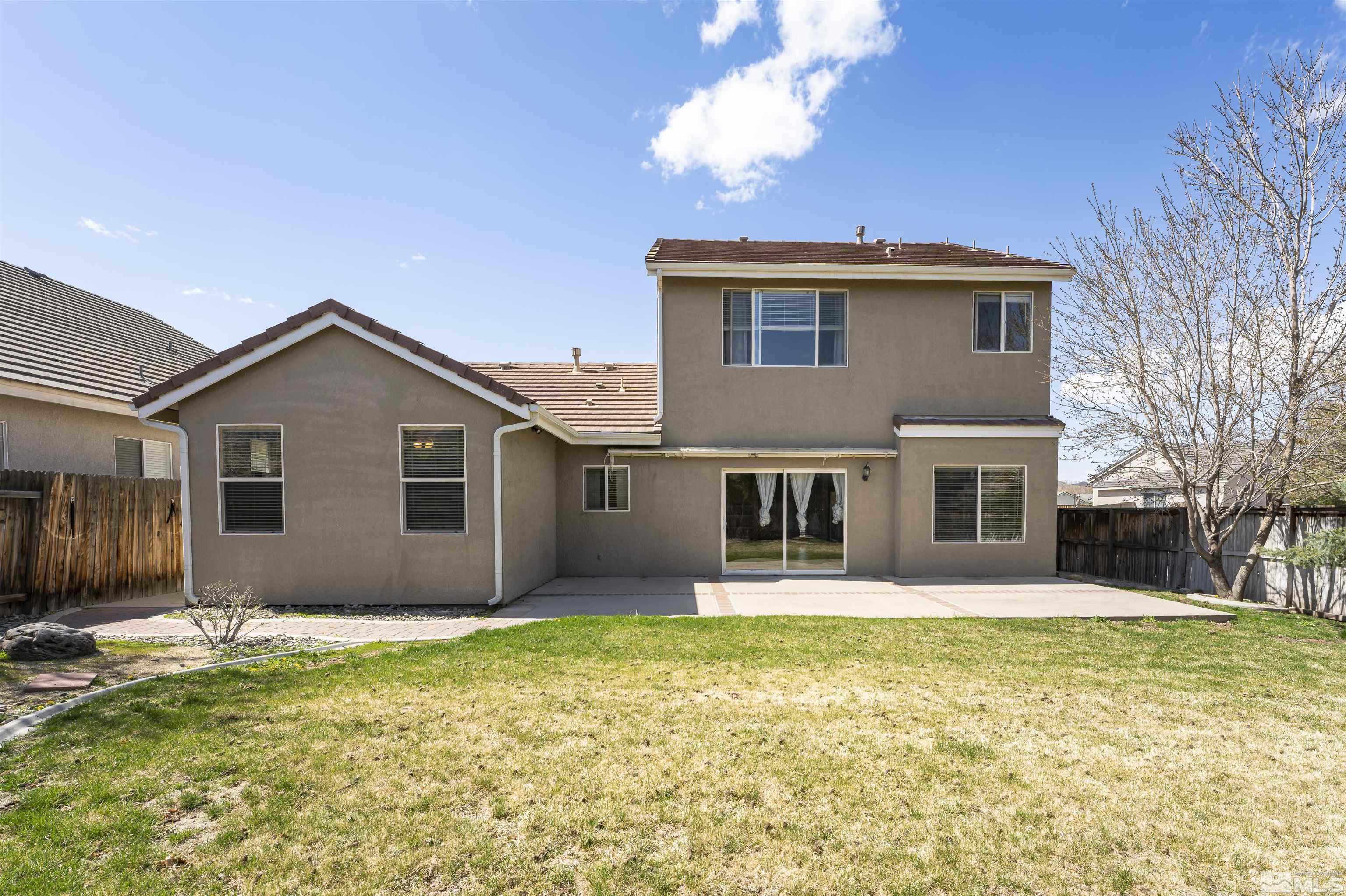 10200 Wolf Ridge Way Reno, NV 89521 - Photo 31 of 40 a front view of house with yard and trees in the background