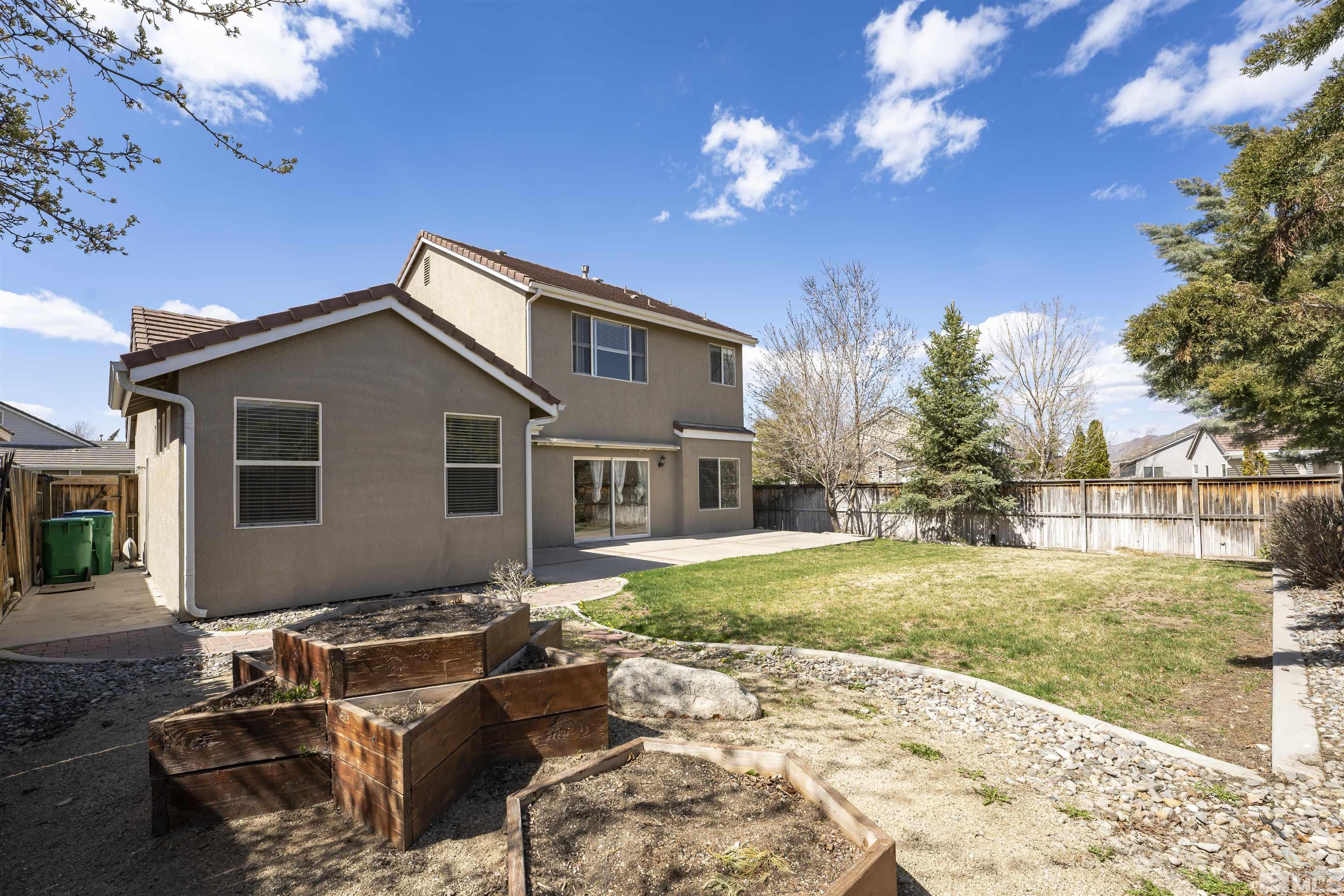 10200 Wolf Ridge Way Reno, NV 89521 - Photo 32 of 40 a backyard of a house with yard fire pit and outdoor seating