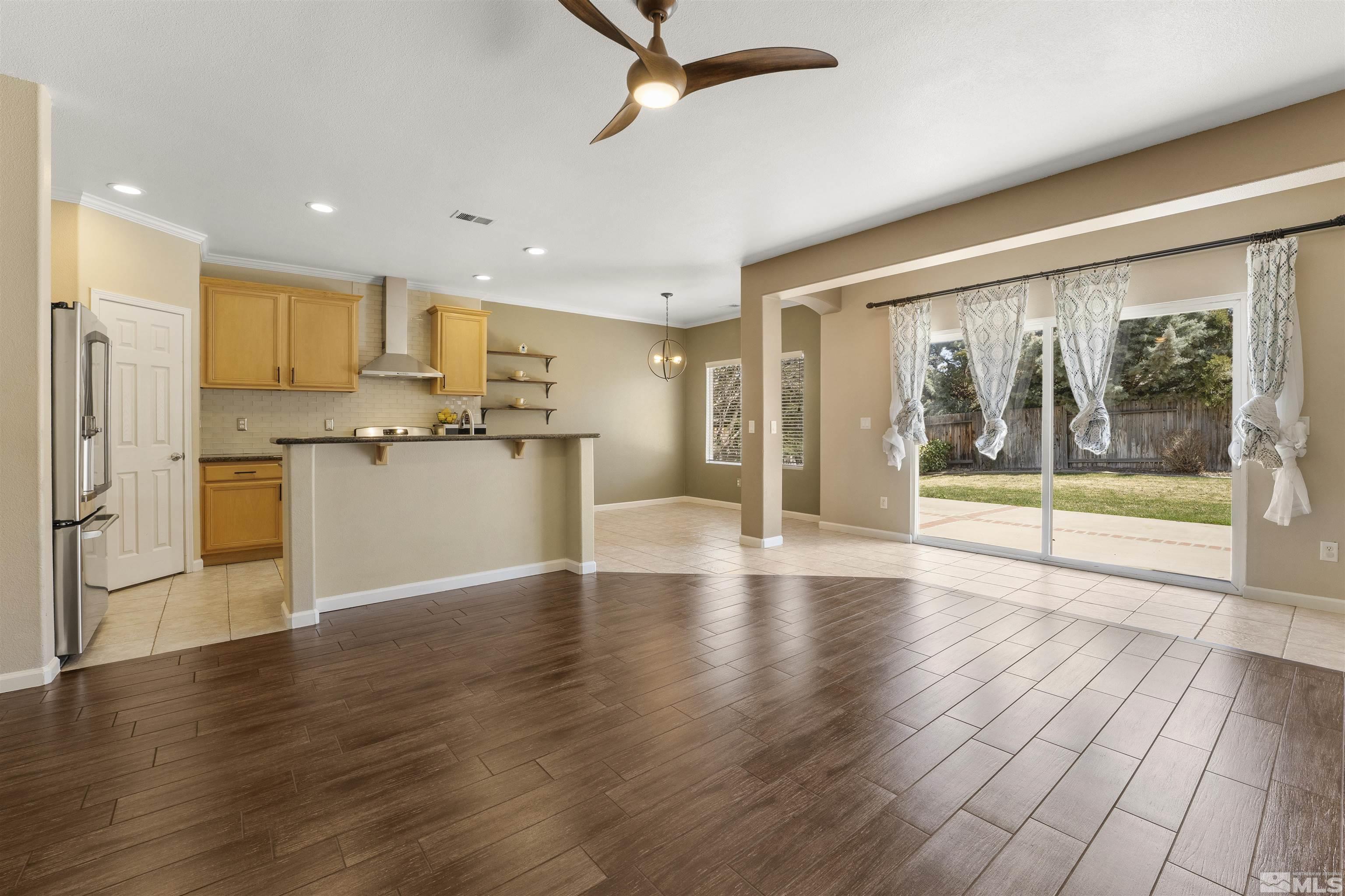 10200 Wolf Ridge Way Reno, NV 89521 - Photo 7 of 40 a view of kitchen with refrigerator and wooden floor