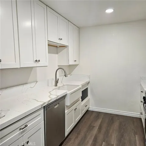 a view of a kitchen with sink washer and dryer