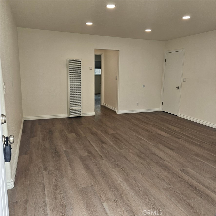 1051 Springfield Street, Unit C Upland, CA 91786 - Photo 7 of 14 an empty room with wooden floor and windows