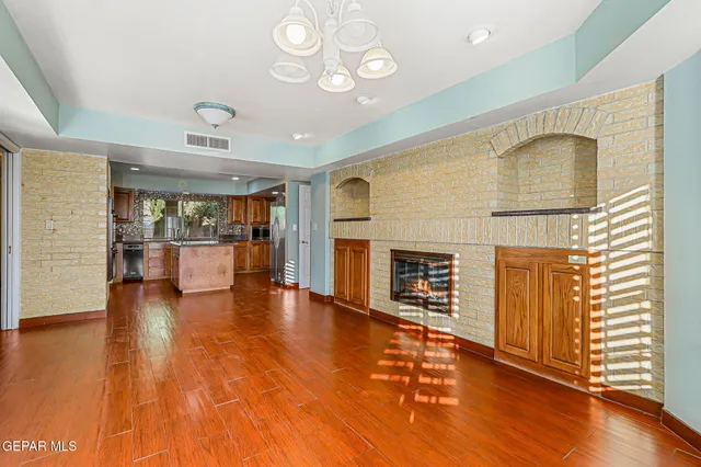 a kitchen with granite countertop a sink stove and refrigerator