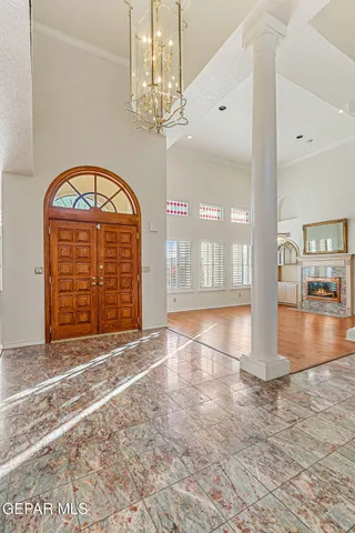a view of a hallway with wooden floor and windows