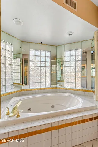 a bathroom with a bathtub and shower