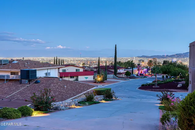 a view of a chairs and table in the backyard