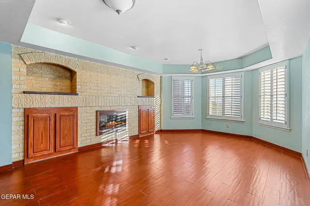 a view of a livingroom with furniture wooden floor and window