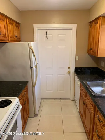 a kitchen with a sink a stove and a refrigerator