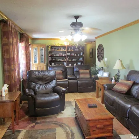 a living room with furniture and a chandelier