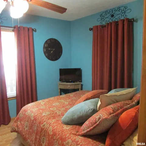 a bedroom with a bed and a wall painting