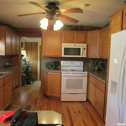 a kitchen with a sink appliances and cabinets