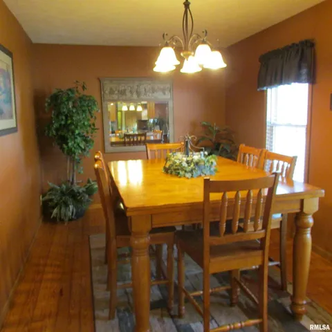 a view of a dining room with furniture and chandelier