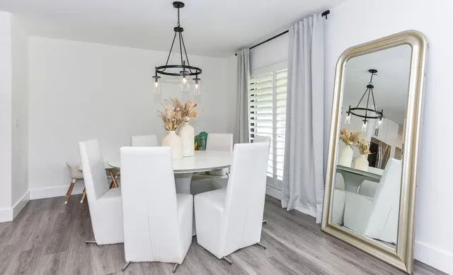 a dining room with furniture and wooden floor