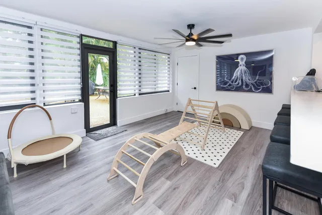 a living room with furniture a rug and a window