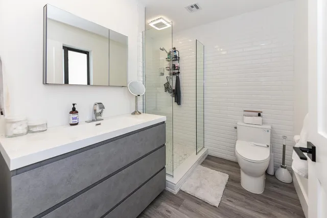 a bathroom with a sink toilet and shower