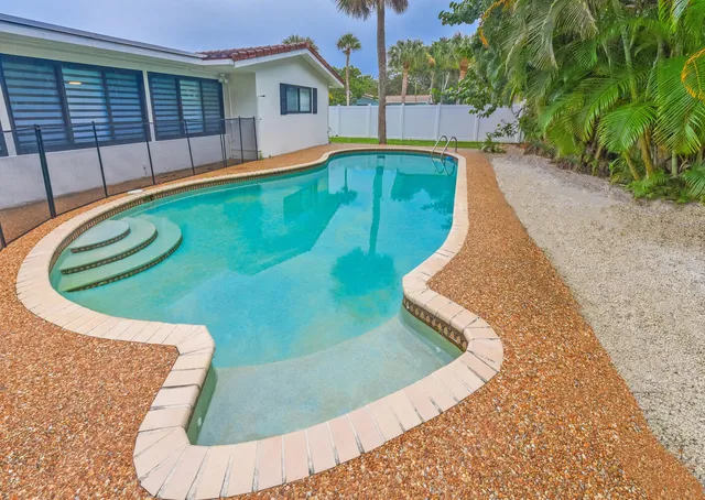 a view of a swimming pool with a patio