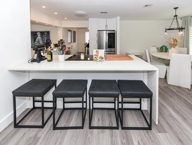 a dining room with furniture and wooden floor