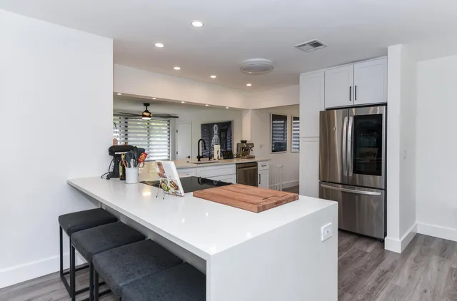 a kitchen with refrigerator cabinets and wooden floor