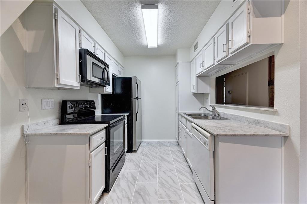 908 Poplar Street, Unit 204 Austin, TX 78705 - Photo 4 of 15 a kitchen with stainless steel appliances granite countertop a sink and a stove