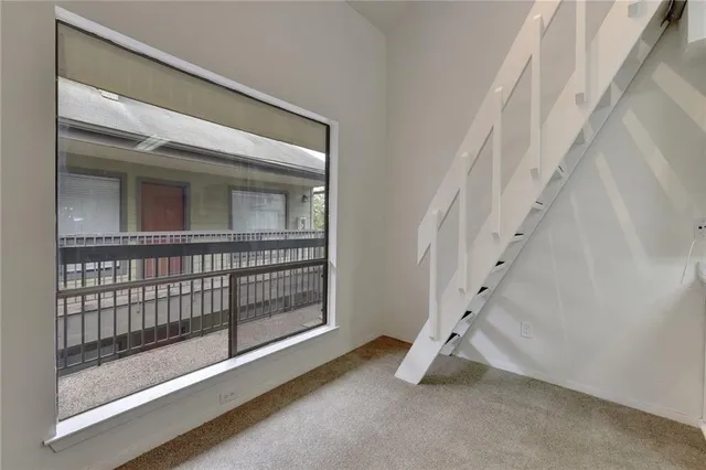 a view of empty room with stairs