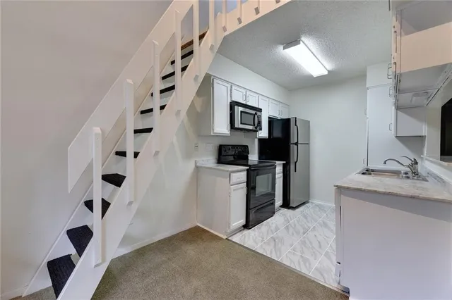 a kitchen with a refrigerator and a sink