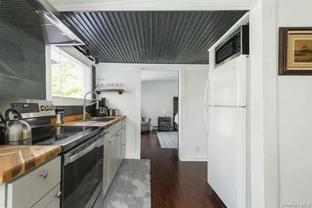 a kitchen with stainless steel appliances granite countertop a sink a stove and a refrigerator