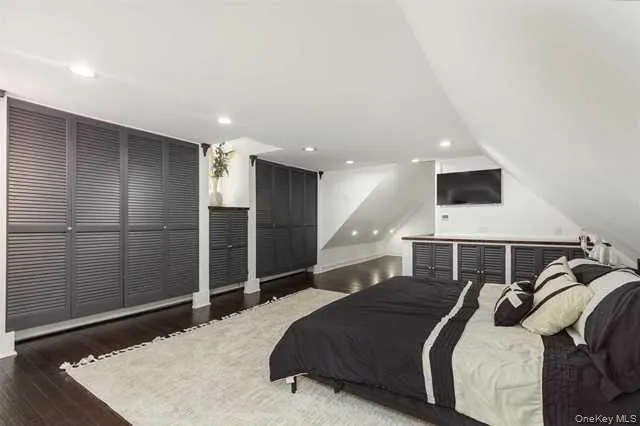 a bedroom with a bed and a refrigerator