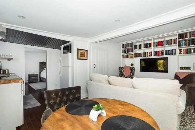 a living room with furniture fireplace and flat screen tv
