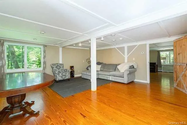 a bedroom with a bed and view of living room