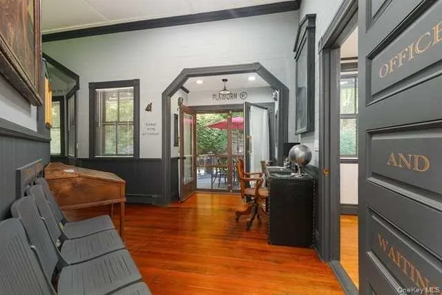 a living room with furniture a fireplace and large windows