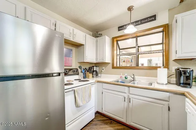 a kitchen with sink cabinets and window