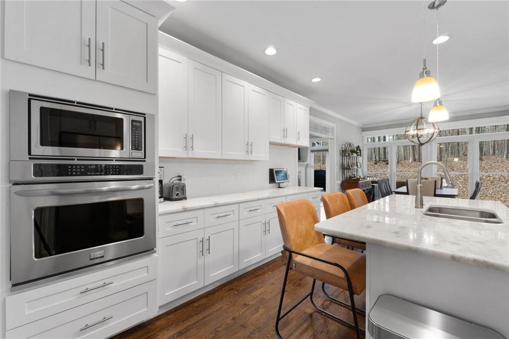 295 Springwater Chase Newnan, GA 30265 - Photo 20 of 68 a kitchen with a stove a microwave and white cabinets