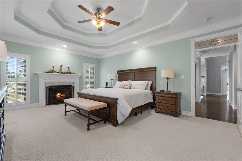 295 Springwater Chase Newnan, GA 30265 - Photo 27 of 68 a bedroom with a bed and a fireplace