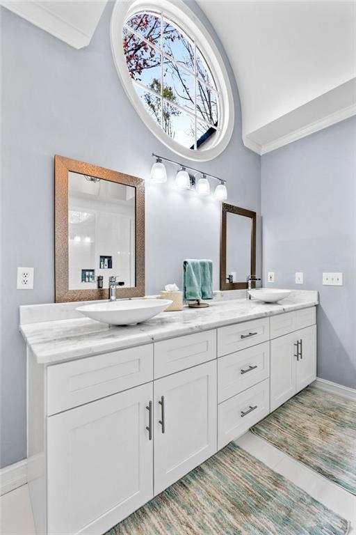 295 Springwater Chase Newnan, GA 30265 - Photo 35 of 68 a bathroom with a granite countertop sink a large mirror and a window