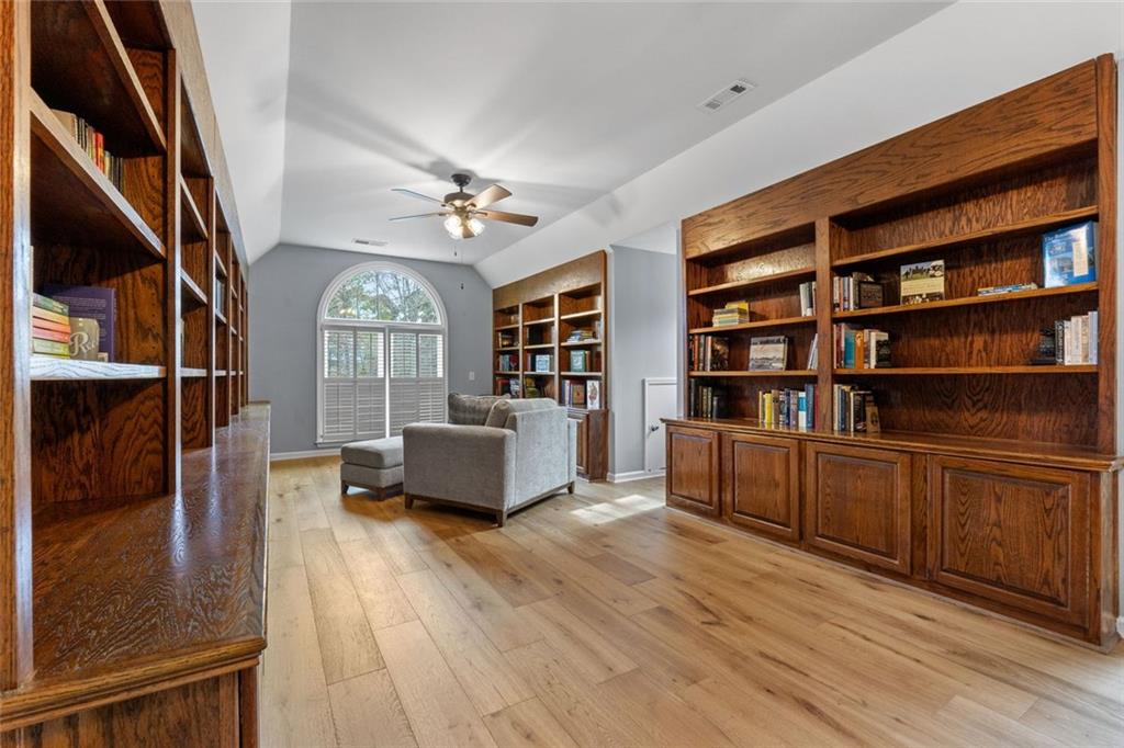 295 Springwater Chase Newnan, GA 30265 - Photo 37 of 68 a living room with furniture and a book shelf