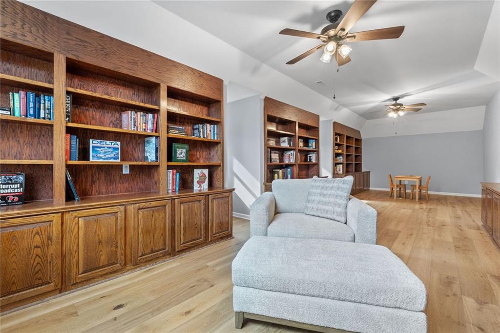 295 Springwater Chase Newnan, GA 30265 - Photo 38 of 68 a living room with furniture and a book shelf