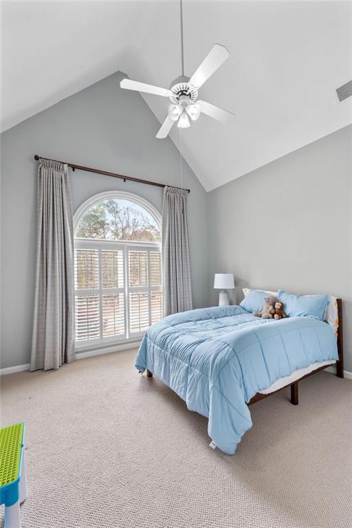 295 Springwater Chase Newnan, GA 30265 - Photo 39 of 68 a spacious bedroom with a bed and a chandelier