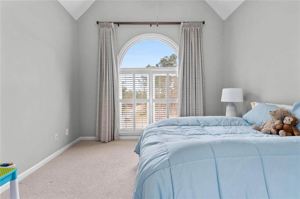 295 Springwater Chase Newnan, GA 30265 - Photo 40 of 68 a bedroom with a bed and a window