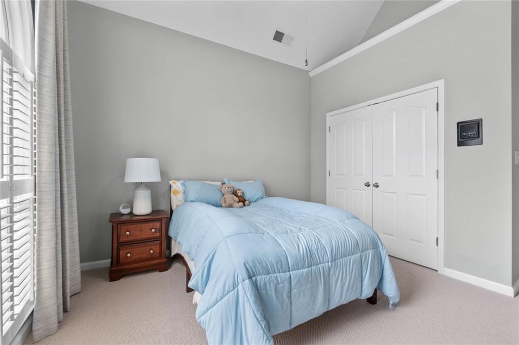 295 Springwater Chase Newnan, GA 30265 - Photo 41 of 68 a bedroom with a bed and a tv