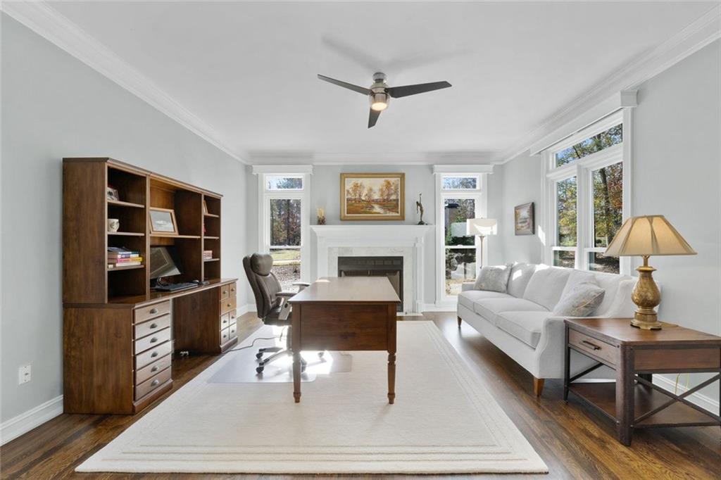 295 Springwater Chase Newnan, GA 30265 - Photo 10 of 68 a living room with furniture a rug and a fireplace