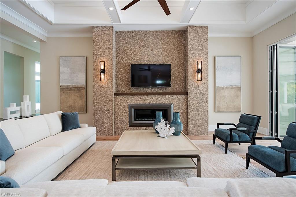 625 Rudder Road Naples, FL 34102 - Photo 8 of 19 a living room with furniture and a fireplace