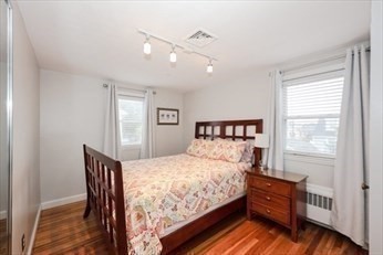 34 Brookline Avenue Hull, MA 02045 - Photo 12 of 18 a bedroom with a bed and wooden floor