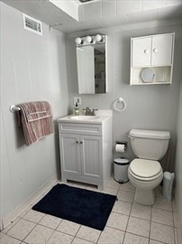 34 Brookline Avenue Hull, MA 02045 - Photo 17 of 18 a bathroom with a toilet a sink and mirror