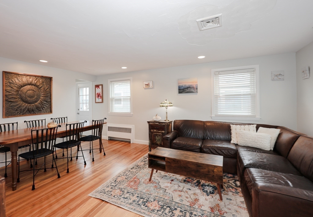 34 Brookline Avenue Hull, MA 02045 - Photo 5 of 18 a living room with furniture a rug and a dining table