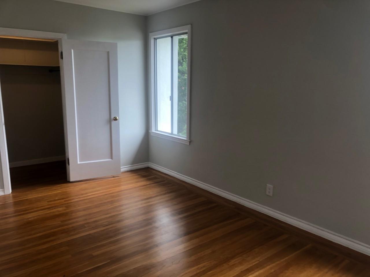 130 El Bonito Way Millbrae, CA 94030 - Photo 27 of 48 an empty room with wooden floor and windows