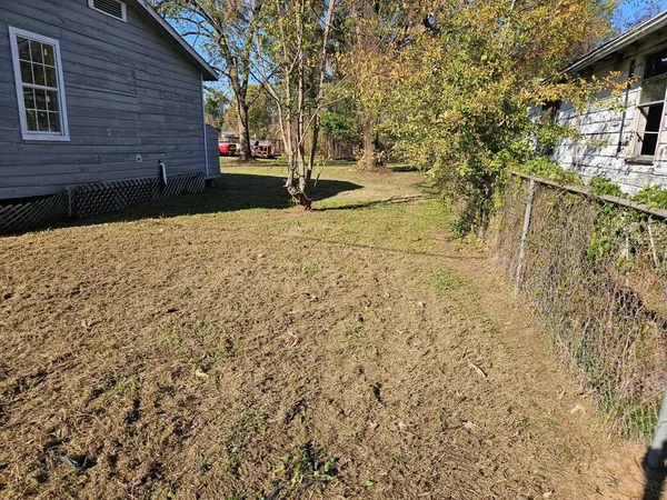 a view of a yard with a tree
