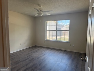 120 Mossydale Lane Albany, GA 31721 - Photo 13 of 20 a view of an empty room with a window and wooden floor