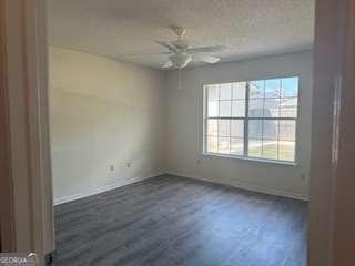 120 Mossydale Lane Albany, GA 31721 - Photo 14 of 20 an empty room with wooden floor and windows