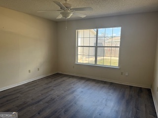 120 Mossydale Lane Albany, GA 31721 - Photo 17 of 20 an empty room with wooden floor and windows