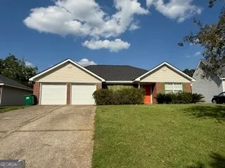 a front view of a house with yard