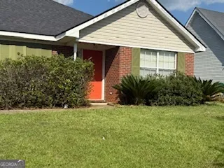 a front view of a house with a garden